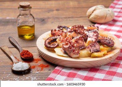 Pulpo a la gallega,galician octopus with potatoes, paprika, salt and olive oil.  Typical Spanish Galician tapa, on a traditional wooden plate. Tipical Spanish tapa concept. 