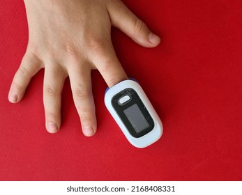 Pulse Oximeter On Child Finger To Measure Pulse Rate And Oxygen Levels. Child Health Concept