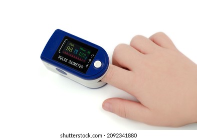 Pulse Oximeter On A Child's Finger On A White Background. Saturation 98 And Pulse 122 In A Child