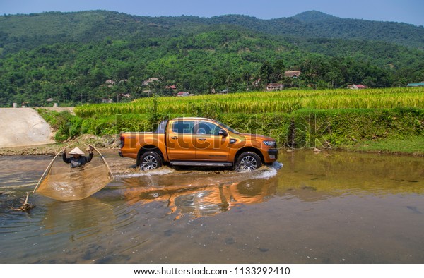 Puluong, Vietnam - June 8,\
2018: Ford Ranger Wildtrak 3.2L is crossing stream in test drive,\
Vietnam.