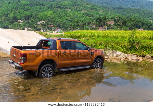 Puluong, Vietnam - June 8,\
2018: Ford Ranger Wildtrak 3.2L is crossing stream in test drive,\
Vietnam.