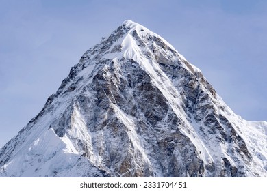 Pumori (or Pumo Ri) is a mountain in the Mahalangur section of the Himalayas.Pumori lies just eight kilometres west of Mount Everest.Pumori's meaning "the Mountain Daughter". Seen during ebc trek. - Powered by Shutterstock