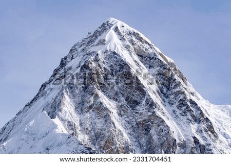Pumori (or Pumo Ri) is a mountain in the Mahalangur section of the Himalayas.Pumori lies just eight kilometres west of Mount Everest.Pumori's meaning 