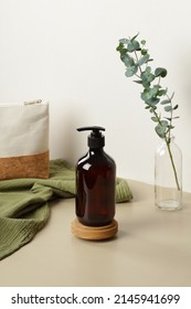 Pump Amber Glass Bottle On Wooden Stand. Soap Liquid, Shampoo Or Shower Gel Packaging Design.