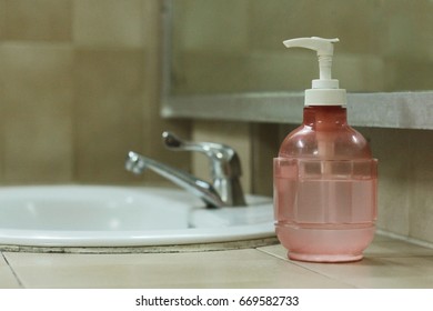 Pump Bottle With Liquid Castile Soap On The Water Sink.