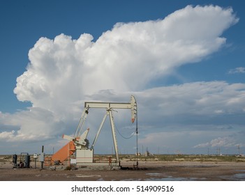 Pump jack pumping oil in west Texas with thunderstorm near Midland/Odessa