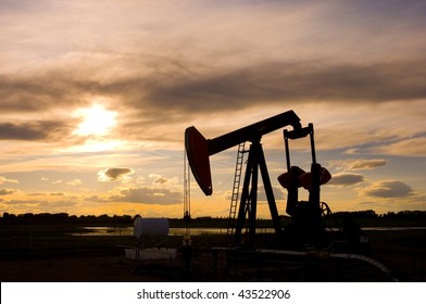 Pump Jack Silhouette At Sunset