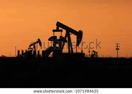Pump jacks silhouette at sunset