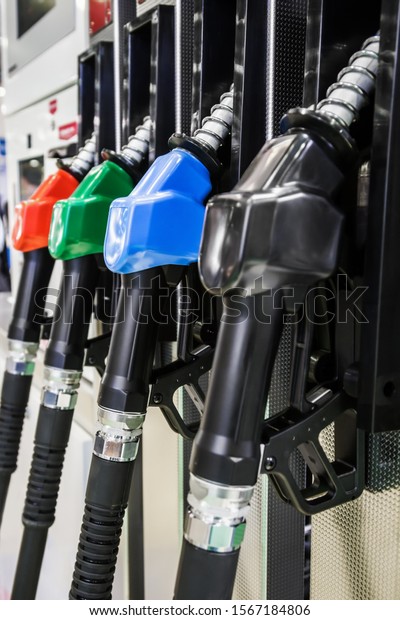 Pump nozzles at the gas station. Shallow\
depth of field with focus on nozzle\
blue