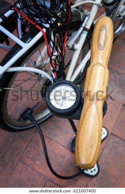 pumping bicycle wheel,\
bicycle pump