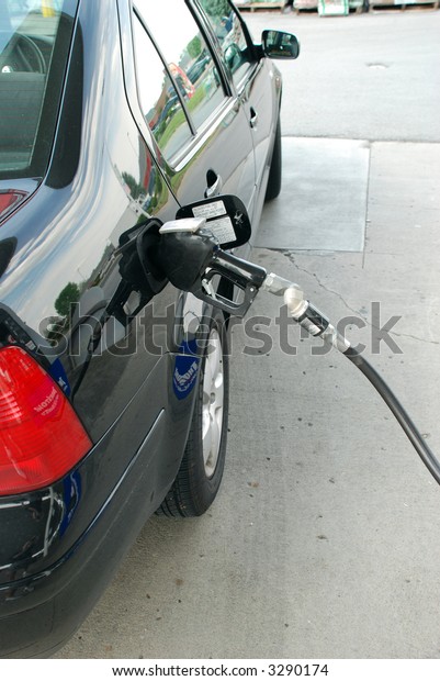 Pumping gas into a\
car