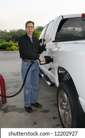 Pumping Gas Into A Gas Guzzling Truck.