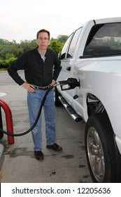 Pumping Gas Into A Gas Guzzling Truck.