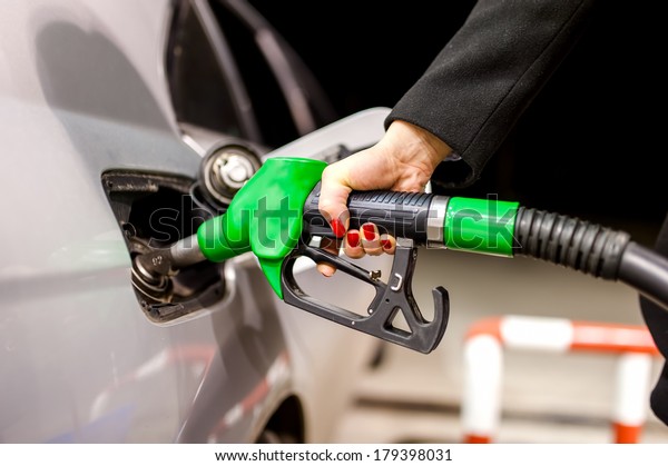 Pumping gas at petrol\
station