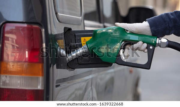 Pumping gas at gas pump. Closeup of man pumping
gasoline fuel in car at gas
station.