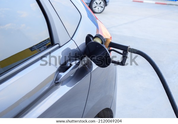 Pumping gas at gas pump. Closeup of man pumping\
gasoline fuel in car at gas\
station.
