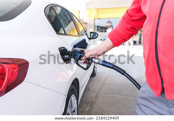 Pumping gas\
at gas pump. Closeup of man pumping gasoline fuel in car at gas\
station, rising gasoline prices, Copy\
Space.