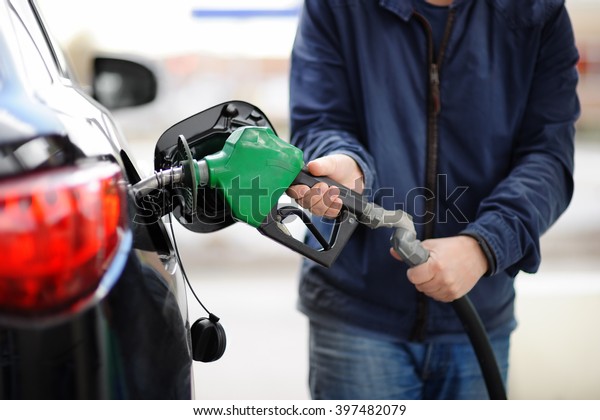 Pumping gas at gas pump. Closeup of man
pumping gasoline fuel in car at gas
station.
