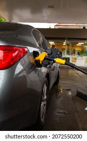 Pumping Gasoline Fuel In Car At Gas Station. Car Refueling Fuel On Petrol Station. Service Is Filling Gas Or Biodiesel Into The Tank.