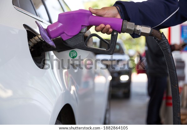 pumping gasoline fuel in car at gas station\
,price gasoline\
concept..