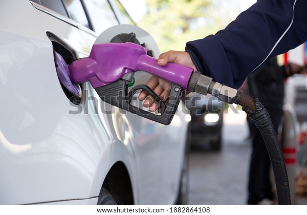 pumping gasoline fuel in car at gas station\
,price gasoline\
concept..