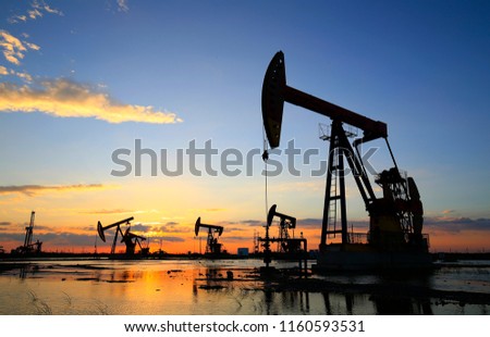 The pumping unit is working in the setting sun