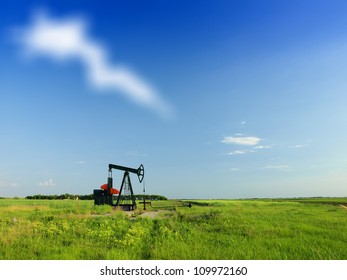 A Pumpjack By A Grassy Field