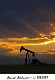 A pumpjack silhoutte with dramatic sunset.