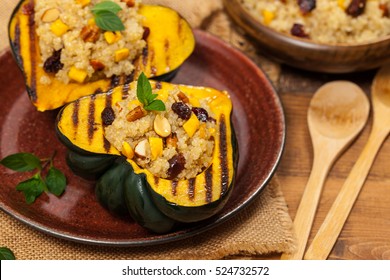 Pumpkin Acorn Stuffed With Quinoa, Nuts And Dried Fruit. Selective Focus.