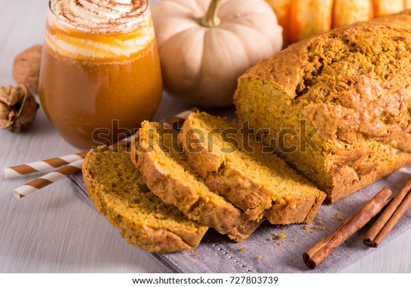 Pumpkin bread cake with pumpkin spice latte for\
autumn fall dinner