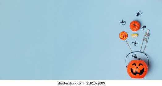 Pumpkin Bucket Jack O Lantern For Halloween On A Blue Background. Banner Flat Lay Copy Space Top View