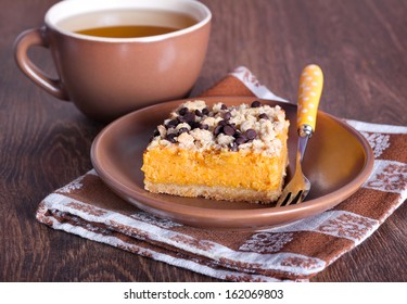 Pumpkin cake with oat and chocolate streusel and cup of tea