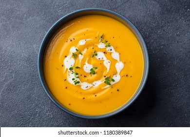 Pumpkin, carrot cream soup in a bowl. Slate background. Close up. Top view. - Powered by Shutterstock