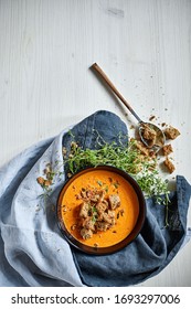 Pumpkin and carrot soup in a ceramic bowl