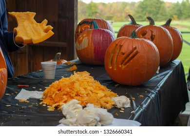 Pumpkin Carving With A Pile Of Guts On A Table