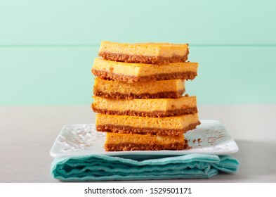 Pumpkin Cheesecake Bars Stack On Plate