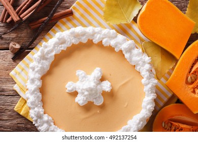 Pumpkin Cheesecake With Cinnamon, Vanilla And Whipped Cream Close-up On The Table. Horizontal View From Above