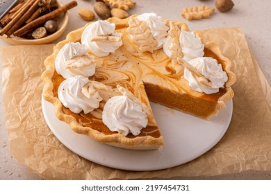 Pumpkin Cheesecake Swirl Pie Topped With Whipped Cream With A Slice Taken Out, Original Thanksgiving Dessert Idea, Overhead View