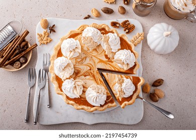 Pumpkin Cheesecake Swirl Pie Topped With Whipped Cream With A Slice Taken Out, Original Thanksgiving Dessert Idea, Overhead View