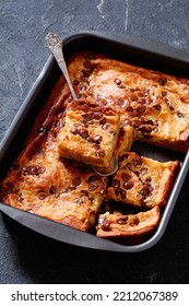 Pumpkin Chocolate Chips Sheet Cake Cut In Slices In A Baking Dish On Dark Concrete Table, Vertical View From Above