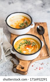 Pumpkin Cream Soup. Pumpkin And Carrot Puree Soup With Turmeric, Cream, Paprica, Chives And Pumpkin Seeds On Grey Background. Vegetarian Cousine. Vegan Recipe. Green Living. Organic Food. Food Styling