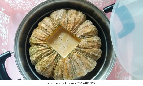 Pumpkin Custard. Thai Traditional Dessert. Mix Eggs With Sugar, Coconut Milk, Pandan And Pour In The Prepared Pumpkin And Steam The Filled Pumpkin High Heat Until Cooked. Close Up