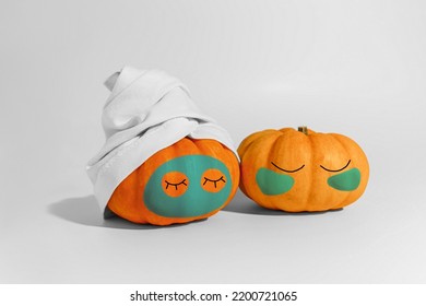 Pumpkin with facial mask and towel isolated on white background. Space for text mockup Spa and Halloween concept - Shutterstock ID 2200721065