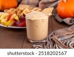 Pumpkin Fluff, Pumpkin spice mousse dip with cookies, fruits, crackers on appetizer serving board for fall, thanksgiving party. Homemade pumpkin puree mixed with vanilla pudding, buttercream, spices