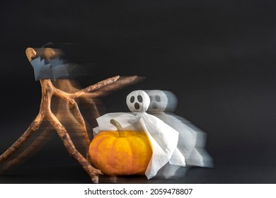 Pumpkin, ghost and bats on black background with blur effect. Copy space