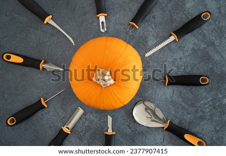 Pumpkin and Halloween carving tools. Pumpkins scooper, saw knife, etching tool, nicking tool, peeler, small sickle, drill, other knives and carvers. Preparing to carve spooky Jack-o'-lantern cut out.