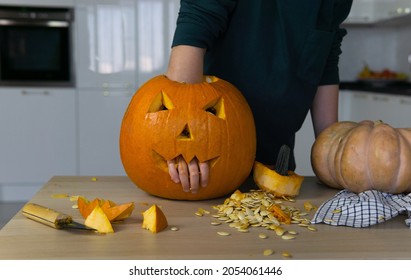 Pumpkin For The Halloween Holiday. A Child Stuck His Hand Inside A Pumpkin Carved For Halloween.