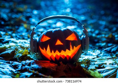 Pumpkin Head Jack With Headphones In Autumn Forest At Night On Leaves, Halloween Music