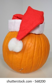 Pumpkin Hiding Under The Disguise Of A Santa Hat