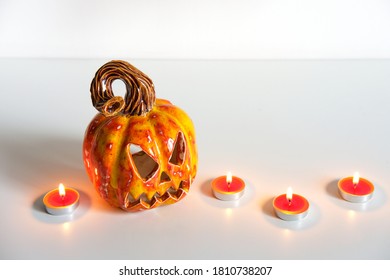 Pumpkin Lantern Jack And Burning Candles. Minimal Halloween Composition. Home Decor.